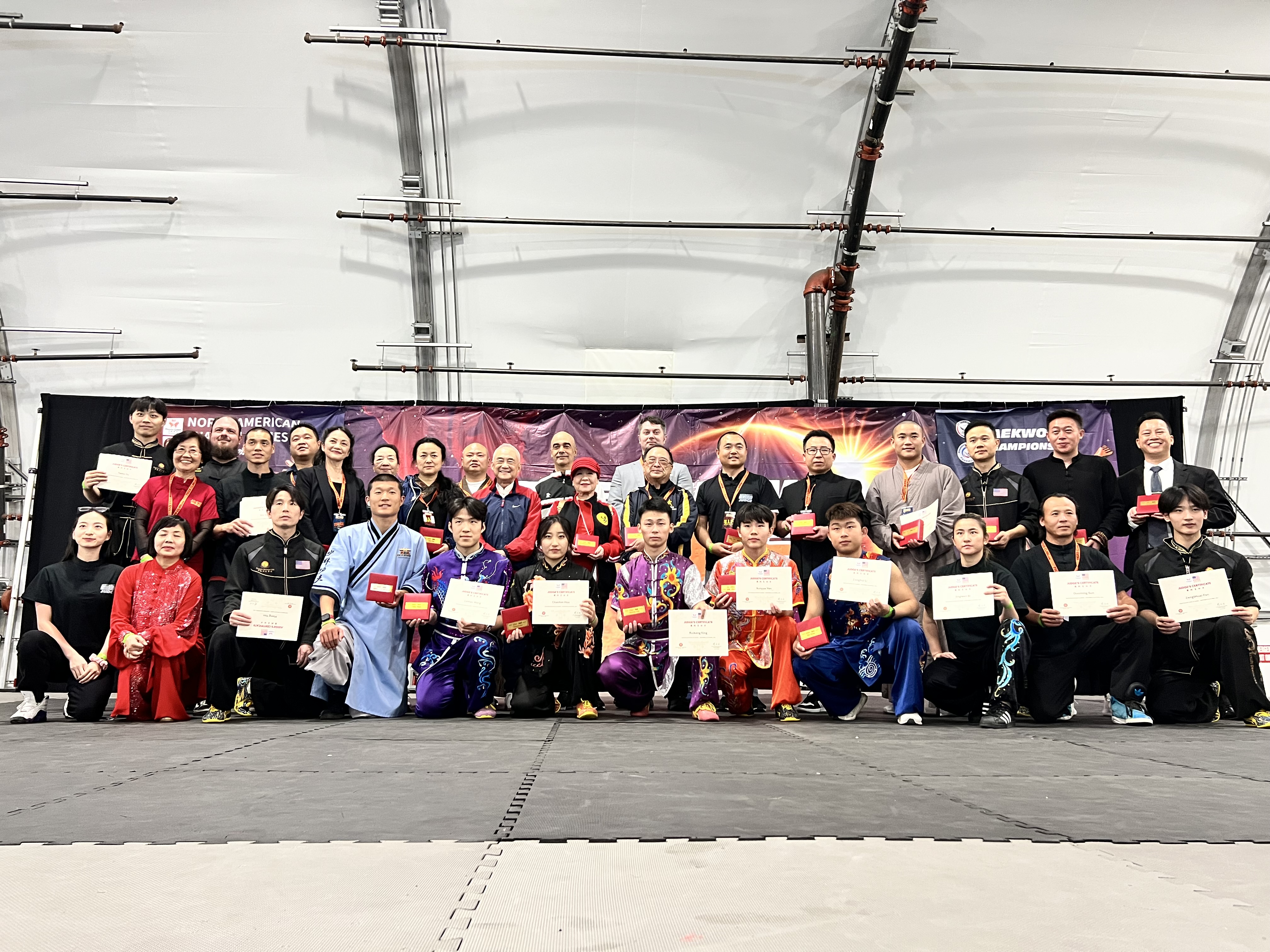 Full team group photo with coaches and competitors at championship