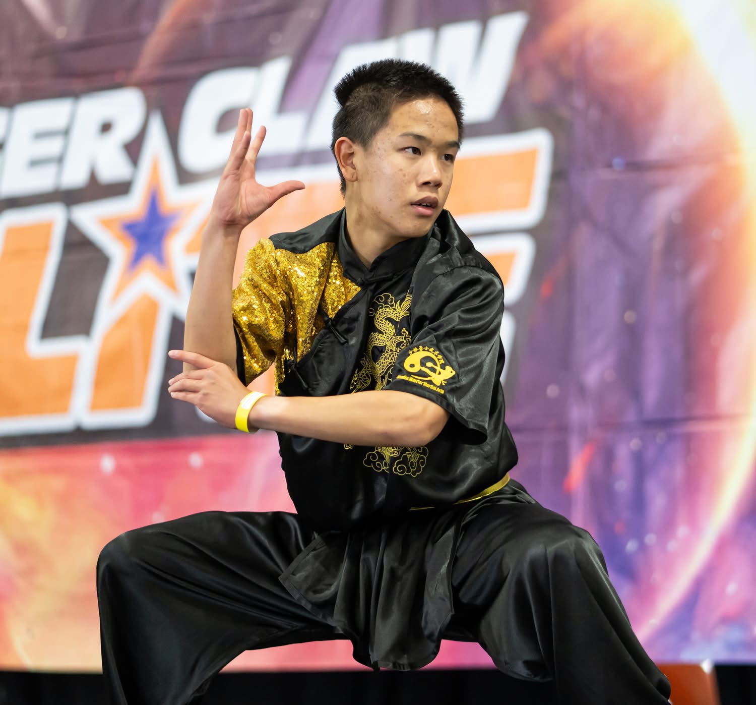 Student holding precise low-dragon stance at competition