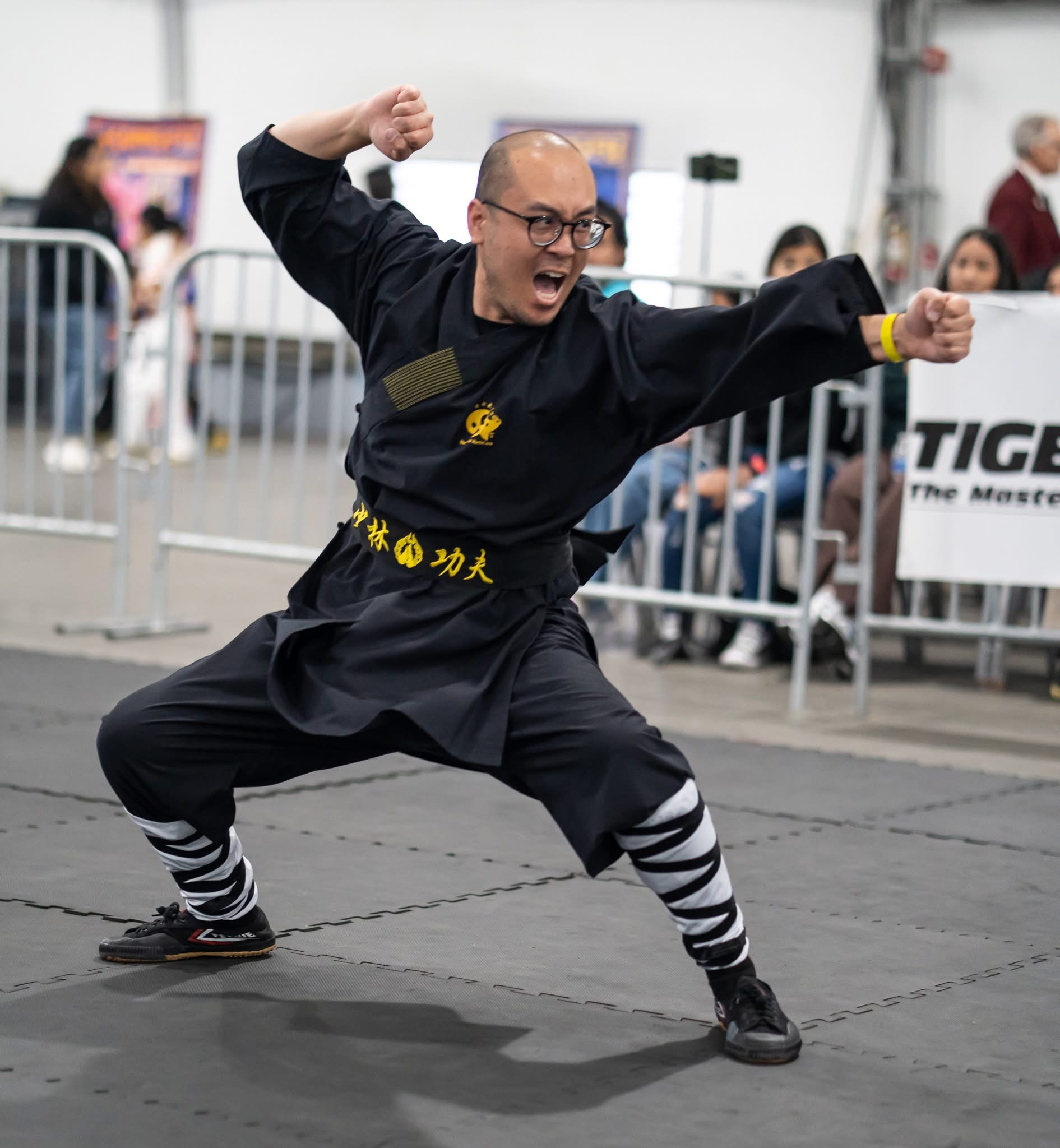 Student jumping with sword at competition