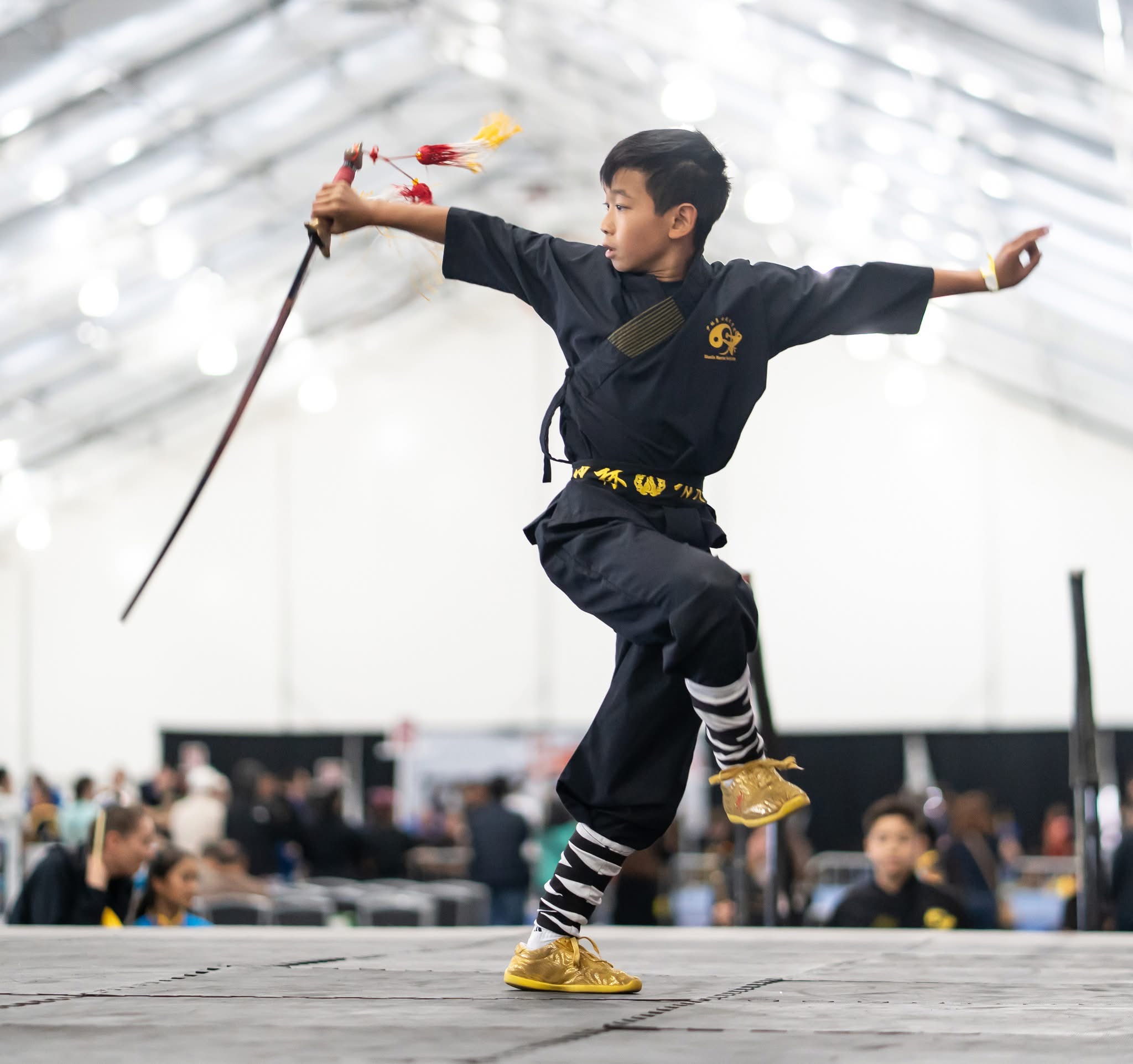 Student airborne with dual broadswords at Tiger Claw Elite