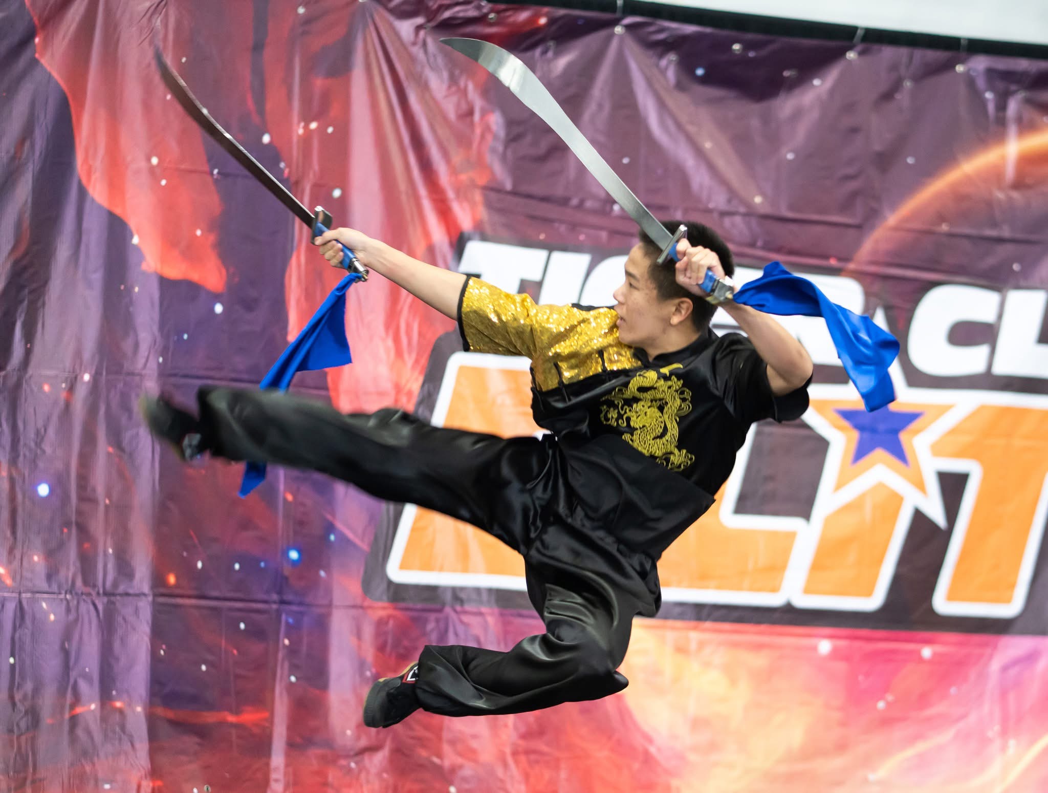 Student in red performing spear form at competition