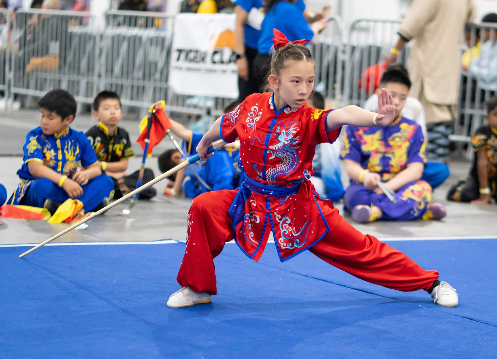 Student performing spear form at outdoor community event